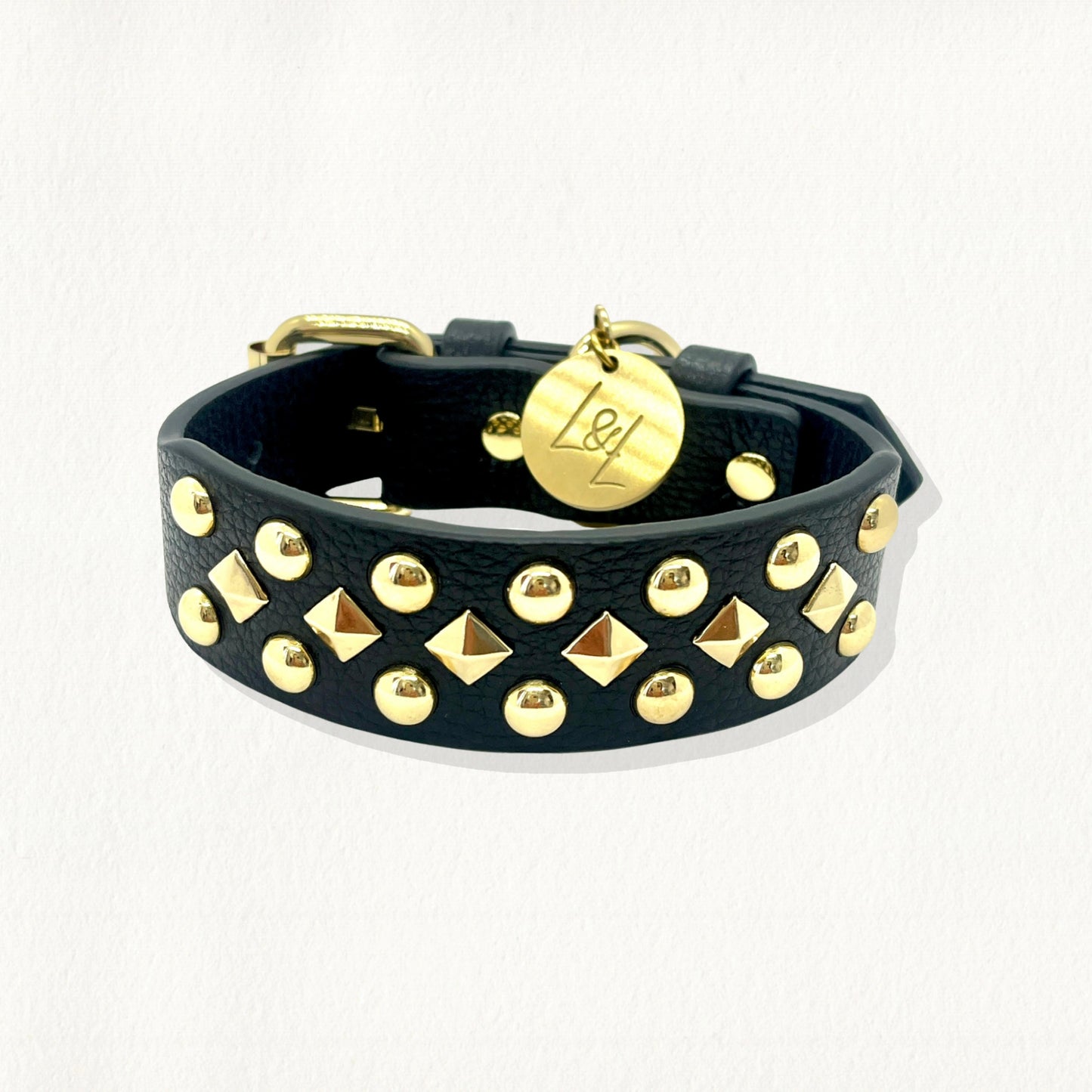 Black pebbled leather dog collar embellished with rows of gold circular studs and pyramid spikes.