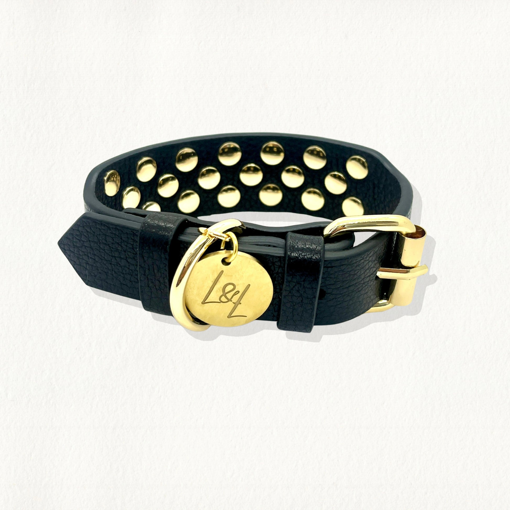 Black leather dog collar with gold studs, featuring a gold buckle closure and "L&L" logo tag.